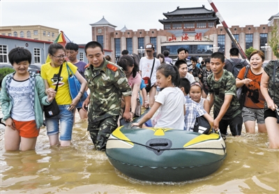 昨日，消防戰(zhàn)士在秦皇島市山海關(guān)火車站涉水運送旅客。當日，受持續(xù)強降雨影響，河北省秦皇島市海港區(qū)、山海關(guān)區(qū)等地出現(xiàn)內(nèi)澇，部分列車停運。 新華社發(fā)