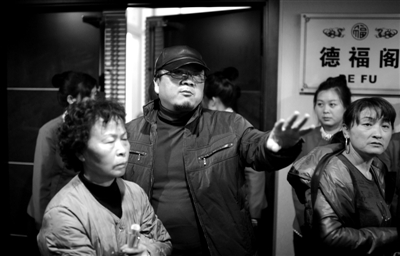 昨日，在河北香河天下第一城，相關(guān)負責人（左二）走出會議室與參加演出的老人們溝通。