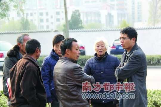 登封法院外，張海超與病人和家屬交談。在許多塵肺病友看來，張海超是一個(gè)大救星。