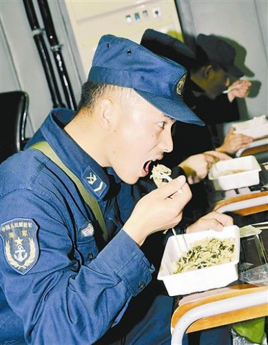 “青島”艦上的官兵在戰(zhàn)位上吃野戰(zhàn)快餐。解放軍報 記者 米晉國攝